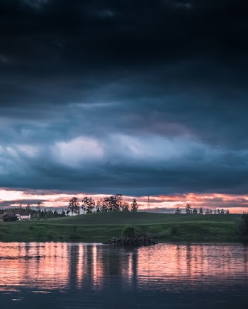 Body Of Water Under Cloudy Sky