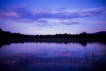 Body of Water Under Purple Sky