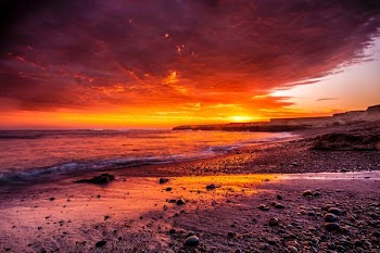 body of water under red sky photo