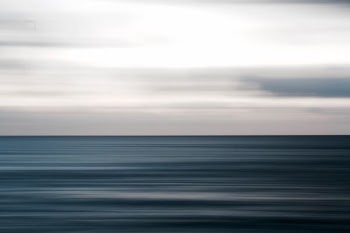body of water under white sky