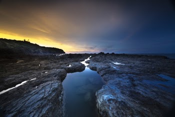 Body of Water With Rock Formation