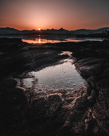 Body of Water With View Of Sunset