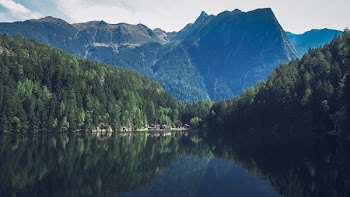 body of water within mountain range during daytime