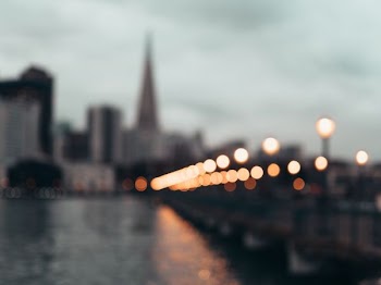 bokeh photography of bridge with light posts