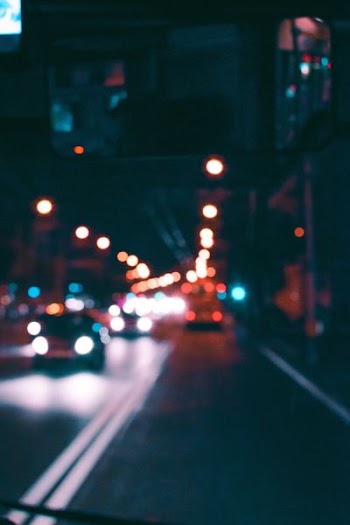 bokeh photography of vehicles on street at night