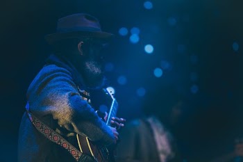 bokeh shot of man playing guitar
