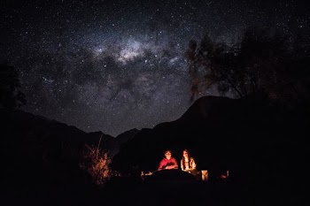 bonfire beside man and woman