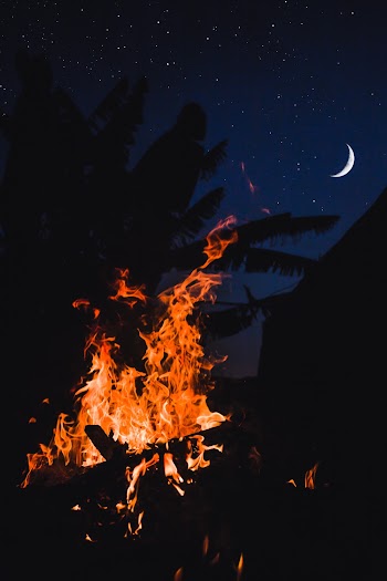 Bonfire Under Crescent Moon in the Sky