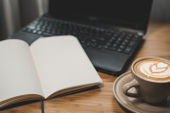Book Page Near Black Laptop
