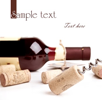 Bottle of wine with corkscrew isolated on white