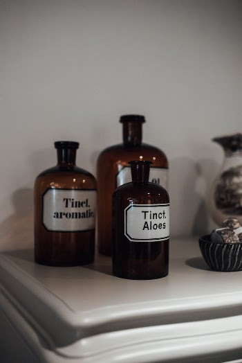 Bottles of natural essential oils on shelf in store
