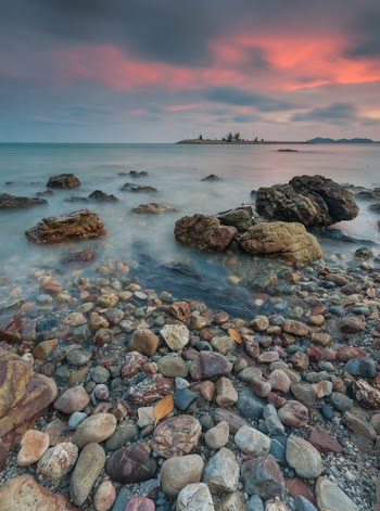 Boulders Near Body of Water during Golden Hour