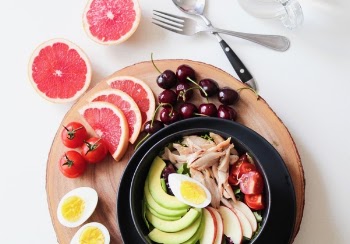 Bowl of Vegetable Salad and Fruits