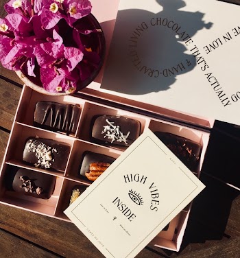 Box of Chocolates Beside Bougainvillea Flower Arrangement