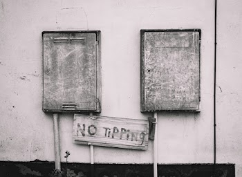 Boxes on Wall With No Tipping Signage