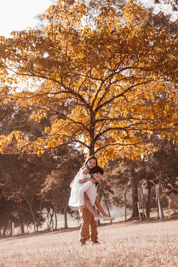 Boy and Girl Near Brown Tree