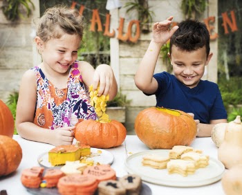 Boy And Girl Playing With Pumpkins 