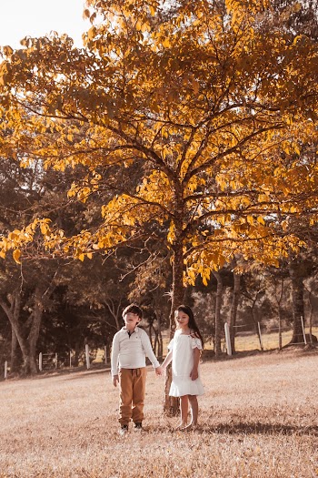 Boy And Girl Standing Under Tree