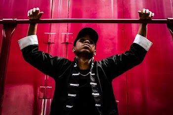 boy both hand hanging on metal bar