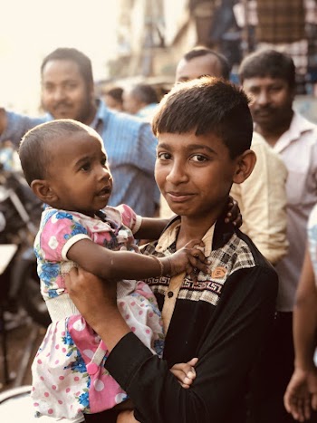 Boy Carrying a Child
