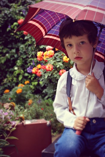Boy Covering Himself Under Red Umbrella