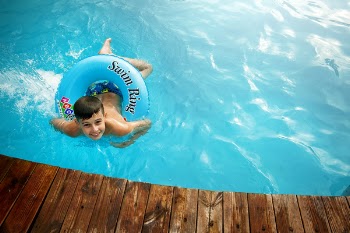 Boy Floating in Pool With Water Ring