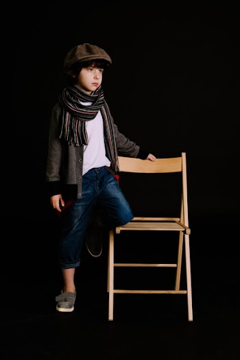 Boy Holding Brown Wooden Chair