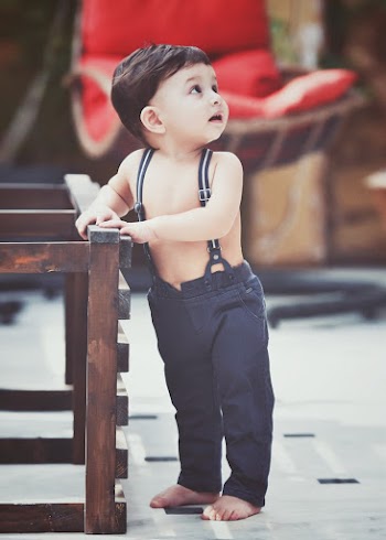 Boy Holding Brown Wooden Frame