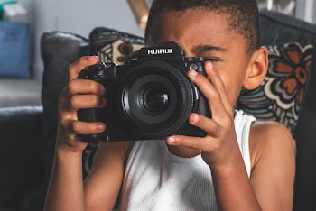 Boy Holding Fujifilm Bridge Camera