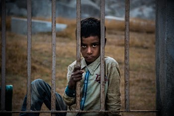 Boy Holding Metal Bar