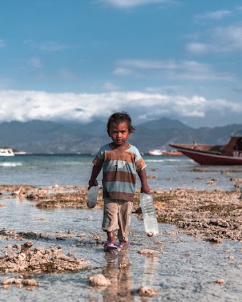 Boy Holding Plastic Bottles