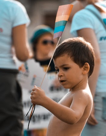 Boy Holding Rainbow Flag