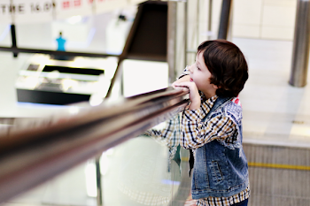 Boy In Denim Vest Leaning On Railing