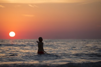 Boy in Ocean during Golden Hour