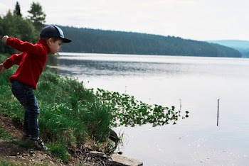 Boy In Red Jacket About To Jump In Water