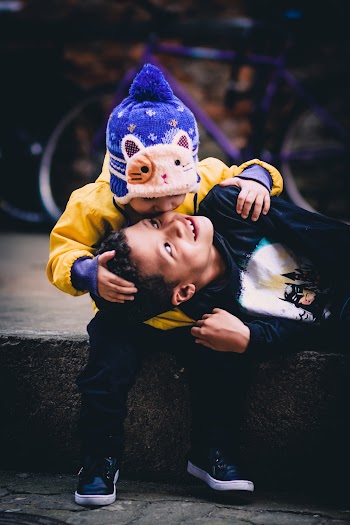 Boy Kissing Another Boy's Cheek