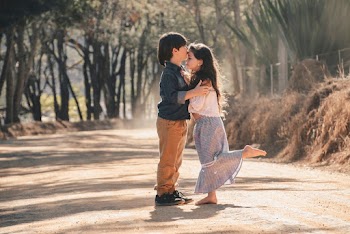 Boy Kissing Girl's Forehead
