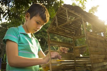 Boy Making Wooden House Miniature