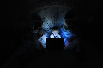 boy playing at laptop inside room