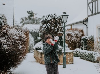Boy Playing Outside While Snowing
