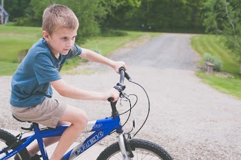 Boy Rides Blue Trek Bike at Daytime
