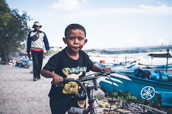 Boy Riding on Black Bicycle
