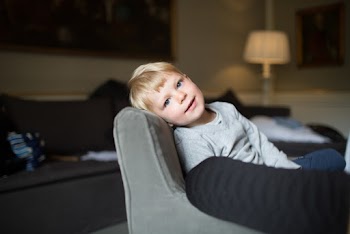 Boy Seated on Sofa