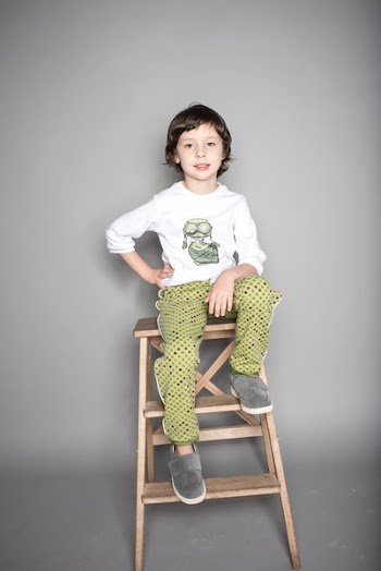 Boy Sitting on Beige Wooden Step Stool