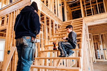 Boy Sitting On Brown Wooden Stairs