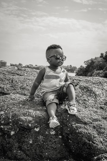 Boy Sitting on Rock