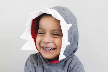 Boy Smiling Wearing Grey And White Hooded Top