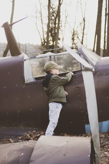 Boy Standing Beside Abandoned Plane