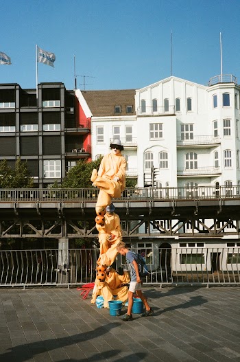 Boy Standing Beside Statue