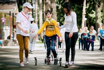 Boy Standing Between Two Women